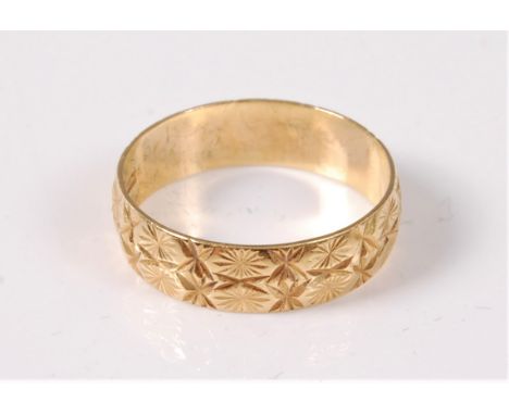 An 18ct wedding band, with engraved decoration, hallmarked London 1986, J-K, (2.3g), cased
