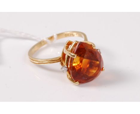 An 18ct citrine and diamond ring, the fancy cut citrine set with a single diamond highlight to either side, all claw set to a