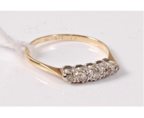 A five stone diamond ring, the five single cut diamonds, all claw set in white precious metal to a plain band of yellow preci