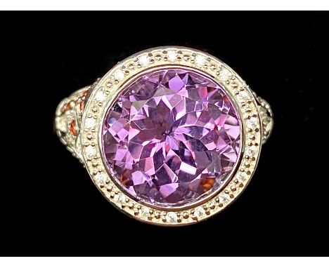 Amethyst and Garnet Stylish Ring, a 6ct round cut amethyst, with a halo of small white topaz, set above a trellis mount of rh