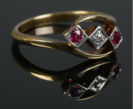 An 18ct Gold and Platinum three stone Ruby and Diamond twist ring. Size U. Total weight: 4.6g  