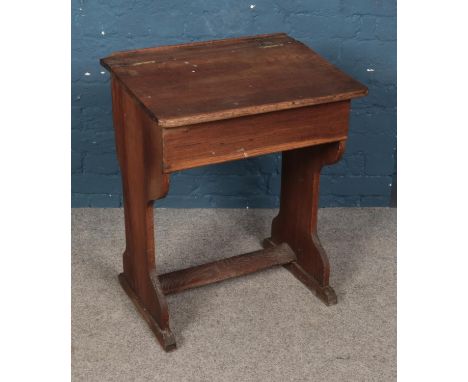 An oak school desk featuring fitted inkwell and hinged compartment. Approx. dimensions 61cm x 45cm x 72.5cm.  