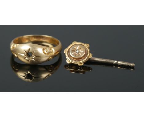 An 18ct solitaire ring and pin. 3.9g  Ring missing stone and pin has broken end.