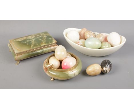 A collection of decorative hardstone eggs along with trinket dish and box.  