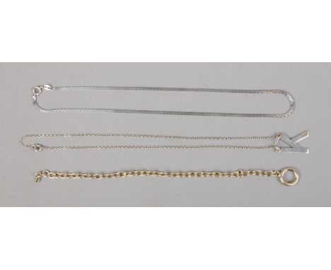 Two silver necklaces, including 'K' pendant example, and one silver gilt bracelet.  