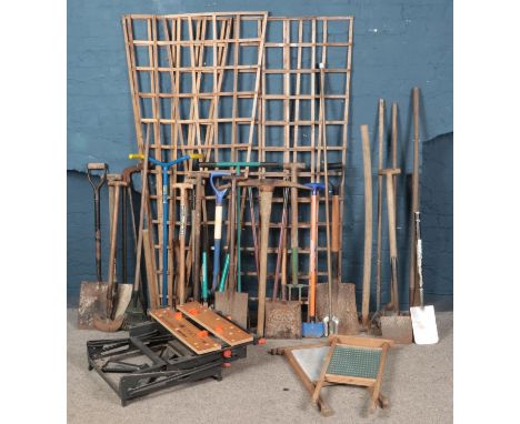 A large quantity of garden tools. Includes shovels, hoes, pitchforks, hedge cutters,  