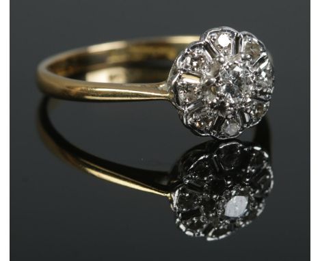 A mid twentieth century 18ct Gold and Platinum Diamond cluster ring, with central brilliant cut stone approximately 0.2ct. Si