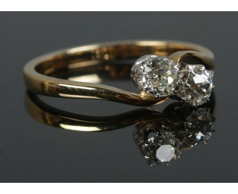 An 18ct Gold two stone diamond ring; Old European cut, with each stone approximately 1/4ct (4mm x 4mm x 3mm). Size OÂ½. Total