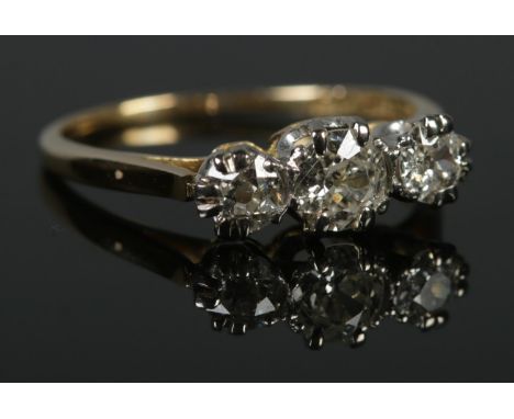 An 18ct Gold and Platinum three stone diamond ring. Largest stone over Â¼ct, with a diameter of 5mm. Size N. Total weight: 2.