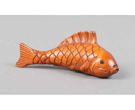 A Japanese carved Netsuke in the form of a Koi carp. Signed. Approx. length 6.5cm.  
