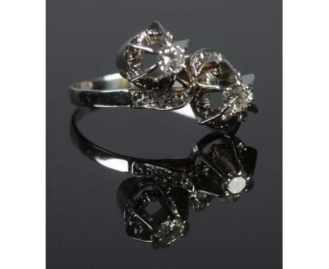 An 18ct White Gold and Diamond 'moi et toi' ring. Stone sizes 1/8ct. Size O. Total weight: 3.2g.  