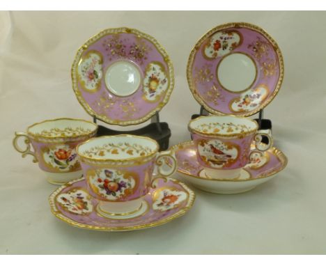 Two H and R Daniel porcelain coffee cups and saucers, First Gadroon shape, decorated with a pink ground and fruit and floral 