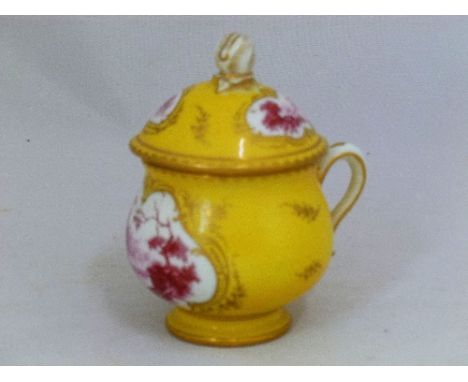 An early 19th century porcelain custard cup and cover, with flower bud finial, yellow ground, gilt details and decorated in m