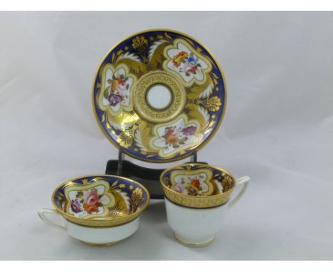 An H & R Daniel porcelain trio in the Etruscan shape, with cobalt blue ground, gilt detail and decorated with floral sprays, 
