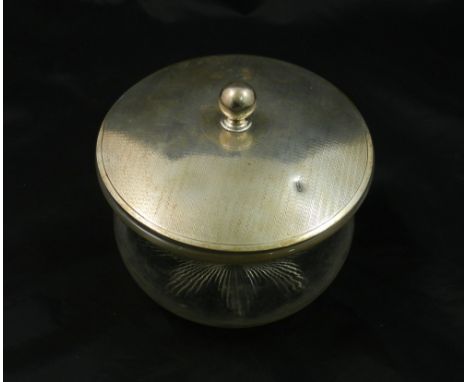 A silver lidded glass biscuit jar, London 1917, with engine turned decoration and spherical knop, the base of the glass jar w