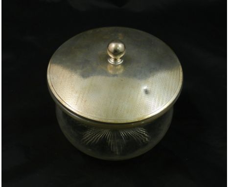 A silver lidded glass biscuit jar, London 1917, with engine turned decoration and spherical knop, the base of the glass jar w