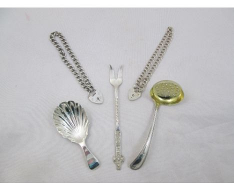 An old English and shell pattern silver caddy spoon, London 1915, a small bead pattern sifter spoon, London 1900, a Celtic cr