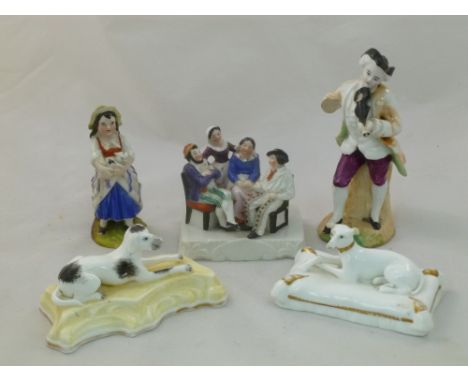 Five pieces of 19th century Continental porcelain comprised of a fairing of a family group, a model of a greyhound on a cushi