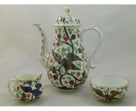 A Royal Worcester porcelain 'Independence Service', coffee pot, cream jug and sugar bowl, the coffee pot signed R Daniel in g