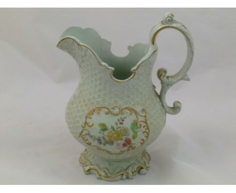 An earthenware milk jug, possibly by H & R Daniel, Mayflower Hybrid shape, with scroll handle, rim and foot, all-over raised 