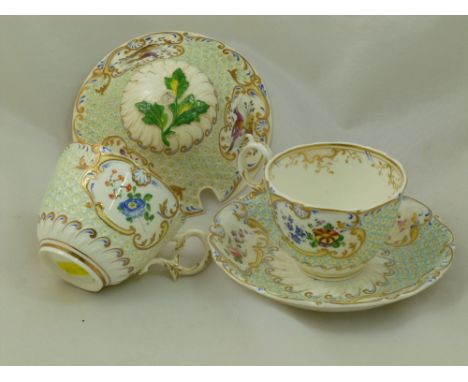 Two H & R Daniel porcelain teacups and a single saucer, Mayflower shape, the raised floral ground finished in blue, decorated