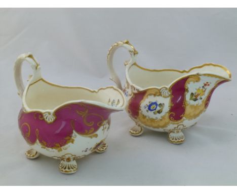 Two H & R Daniel porcelain cream jugs, Shell shape variation B, with acanthus scroll handle and four shell feet, the first wi