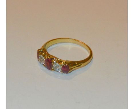 An early 20th century gold, ruby and diamond five stone ring, the three oval mixed cut rubies divided by two old cut diamonds