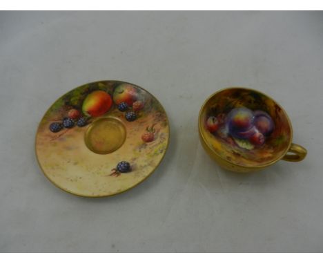 A Royal Worcester miniature teacup and saucer with painted fruit decoration, the teacut decorated with plums and cherries by 