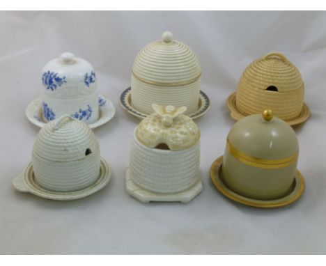 A collection of six honey pots comprised of four Wedgwood examples, a Davenport example and one other with unassociated lid -