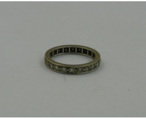 An 18 carat white gold and diamond eternity ring, the round brilliant cut diamonds combined weight approximately 0.60 carats,