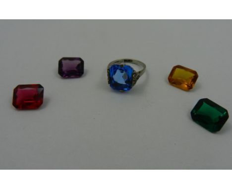 An early 20th century silver and paste set ring with red, yellow, purple, green and blue interchangeable stones, boxed