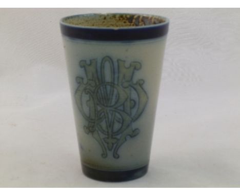 A Martin Brothers stoneware beaker with WMB interwoven initials to the grey body with cobalt blue bands around the rim and th
