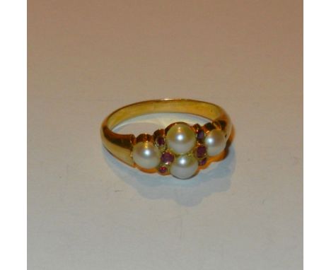A Victorian half pearl and ruby mourning ring, the four half pearls divided by six small oval mixed cut rubies, set between r