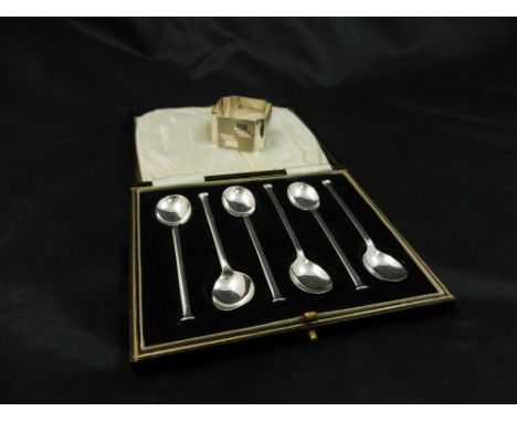 A set of six silver nail head pattern coffee spoons, Sheffield 1927, cased and a square shaped Art Deco napkin ring with engi