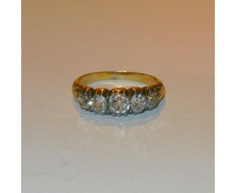 A Victorian gold and diamond five stone half hoop ring, the graduated old cut diamonds housed in silver pinched rub-over sett