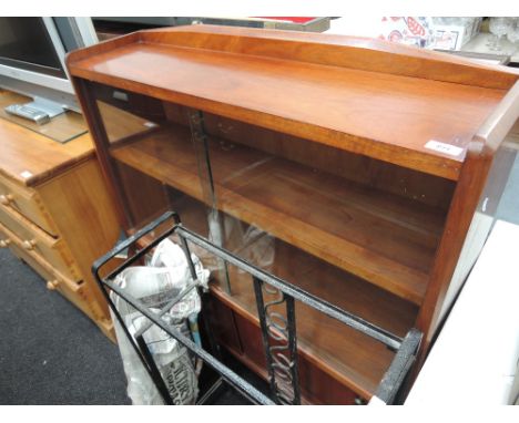 A wrought iron and glass garden shelf unit