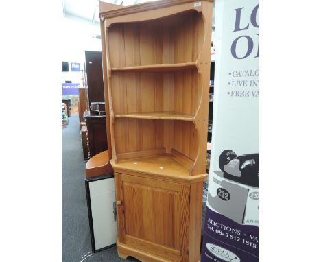 A modern pine corner shelf/cupboard, labelled Ercol