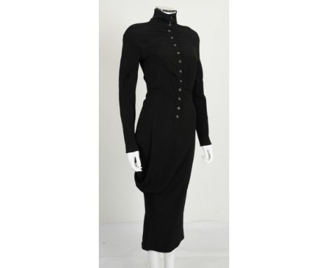 A pre-2002 Alexander McQueen black dress with curved right side, high neck, button fastening along front, long sleeves with b