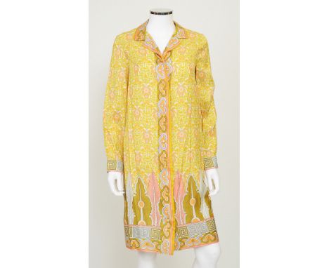 A 1960s silk button up shift dress in a typical 1960s yellow, orange and grey floral design, long sleeves with geometric prin