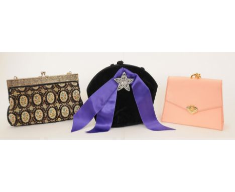 A small black velvet Yves Saint Laurent bag with paste star decoration and purple ribbon to front, rope style hangles, Yves S