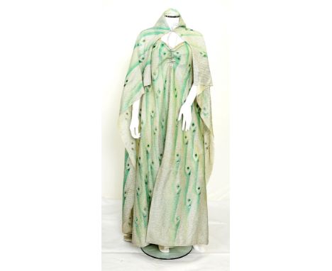 A green tone coloured lamé dress and matching cloak worn by one of the Hawk Woman characters in Flash Gordon, dress with silv