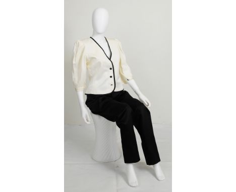 A 1980s Yves Saint Laurent jacket with black trim and blouson sleeves, black button fastening to front and on sleeves, Yves S