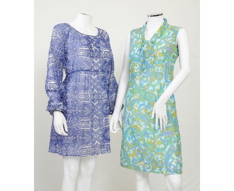 Two 1960s dresses in blue tones; one in paisley pattern with blue tones, low tie neck; one with blue and white geometric desi