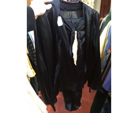 A 1970s black satin sleepwear set which includes a jacket, top and trousers, jacket with button fastening to front and long s