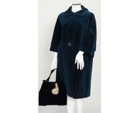 A 1960s blue velvet coat, single button fastening to front, collar with bow decoration; together with a navy blue velvet bag 
