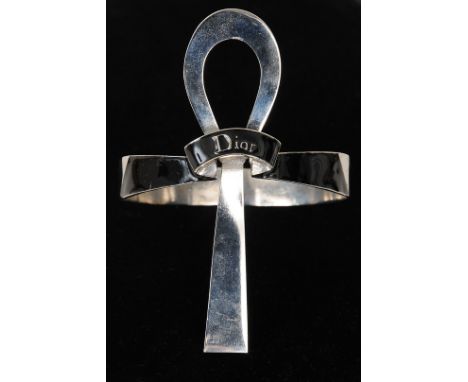 A Christian Dior arm bangle, black enamel band with silvered gilt metal decoration in the shape of the Egyptian cross Ankh, s