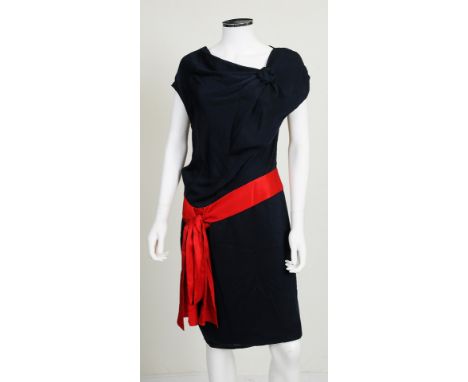 A 2007 silk navy blue Alexander McQueen dress with dramatic red tie to waist, diagonal cut neck with navy blue flower detail,