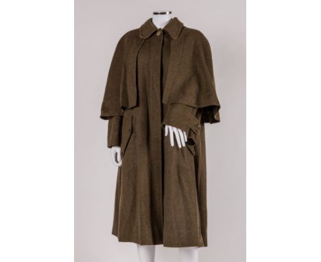 A mans 1970s green Hermès coat made from 85% wool and 15% cashmere with an attached short cape to shoulders, long sleeves wit