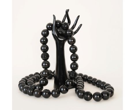 An 1980s black beaded necklace by Christian Dior, either ebony or African black wood, with carved design, Christian Dior stam