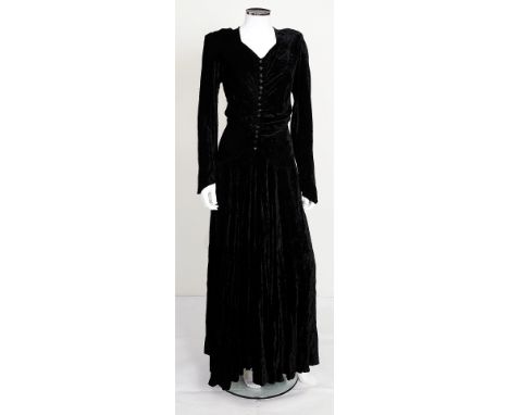 A 1950s long black crushed velvet dress, ruched detailing to front decorated with clear plastic flower studs, long sleeves, s